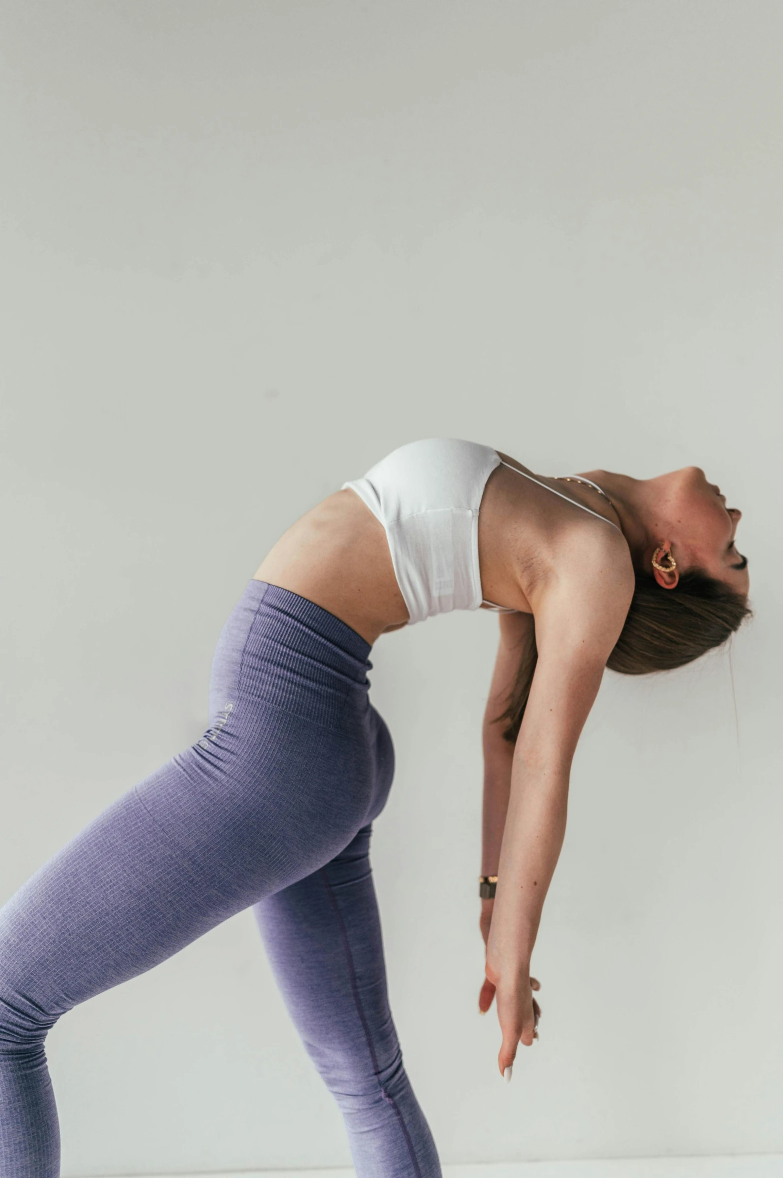 a woman doing the splits exercise with her leg