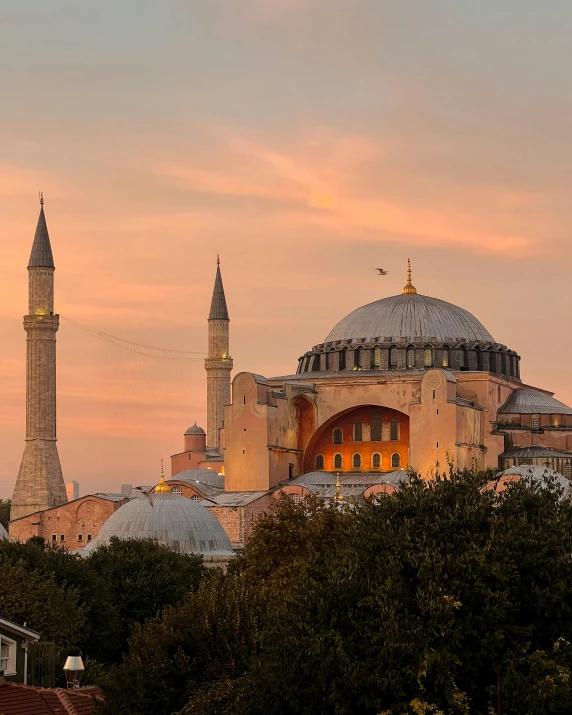 the cathedral of the city is lit up by sunset