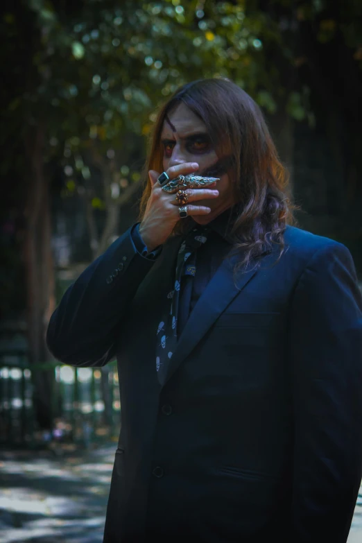 man dressed up in black posing with metal celets