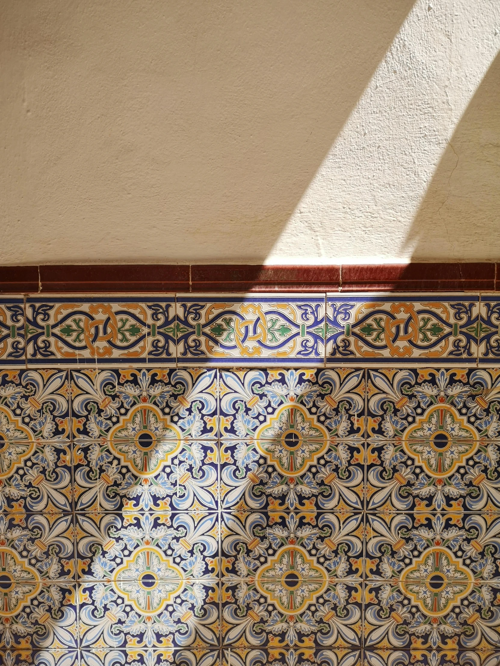 an old tiled wall with blue and yellow tiles