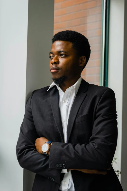 man in black suit posing for picture