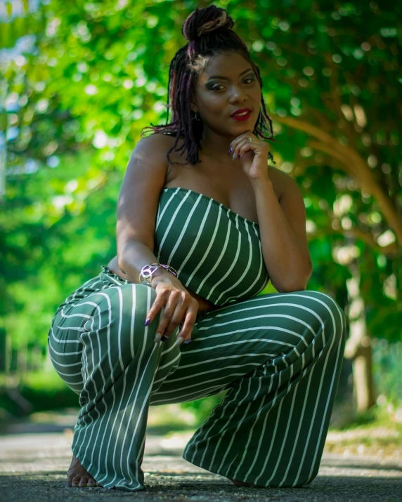 a woman wearing a black watch is posing for the camera