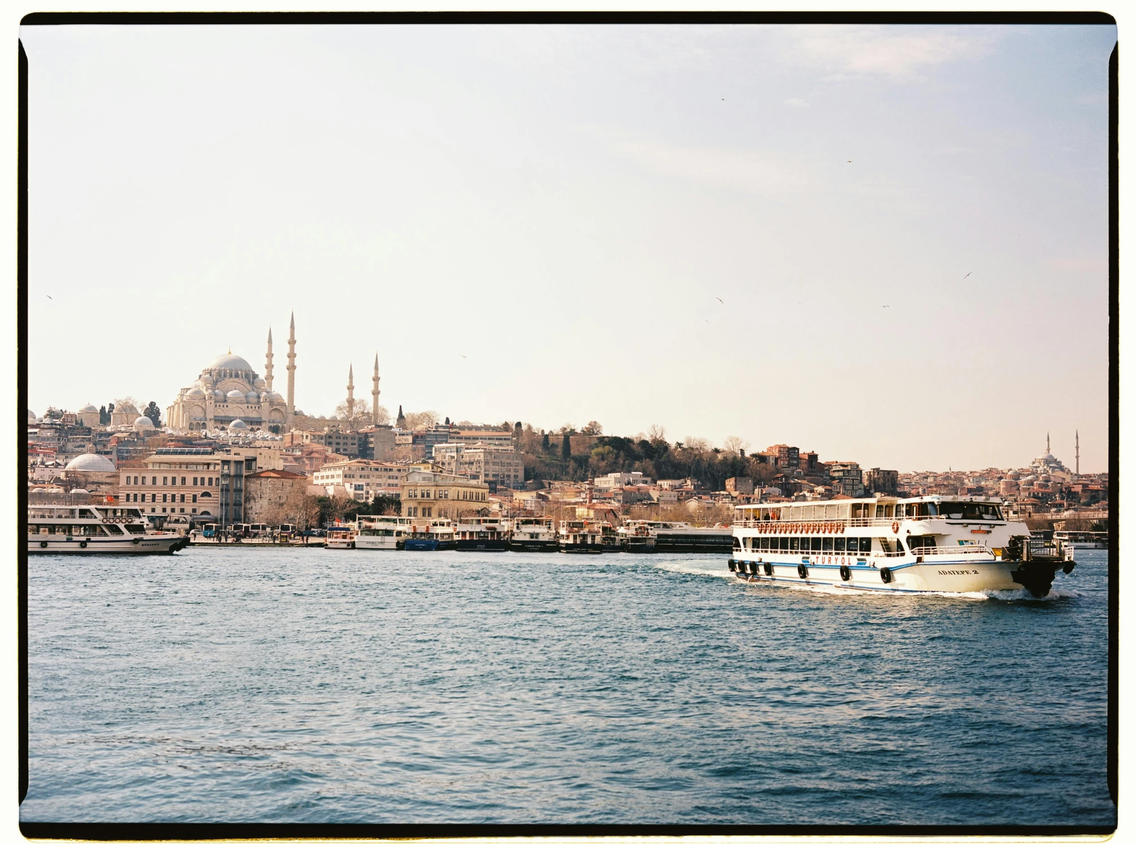 a boat in the water by an old city