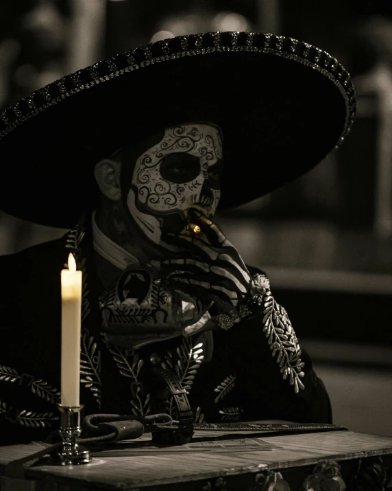 a skeleton wearing a sombrero smoking a cigar
