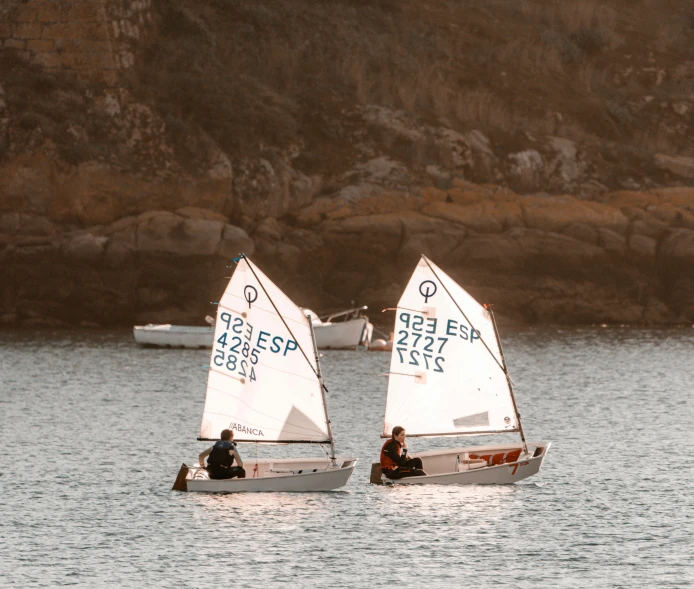 two sailboats in a large body of water