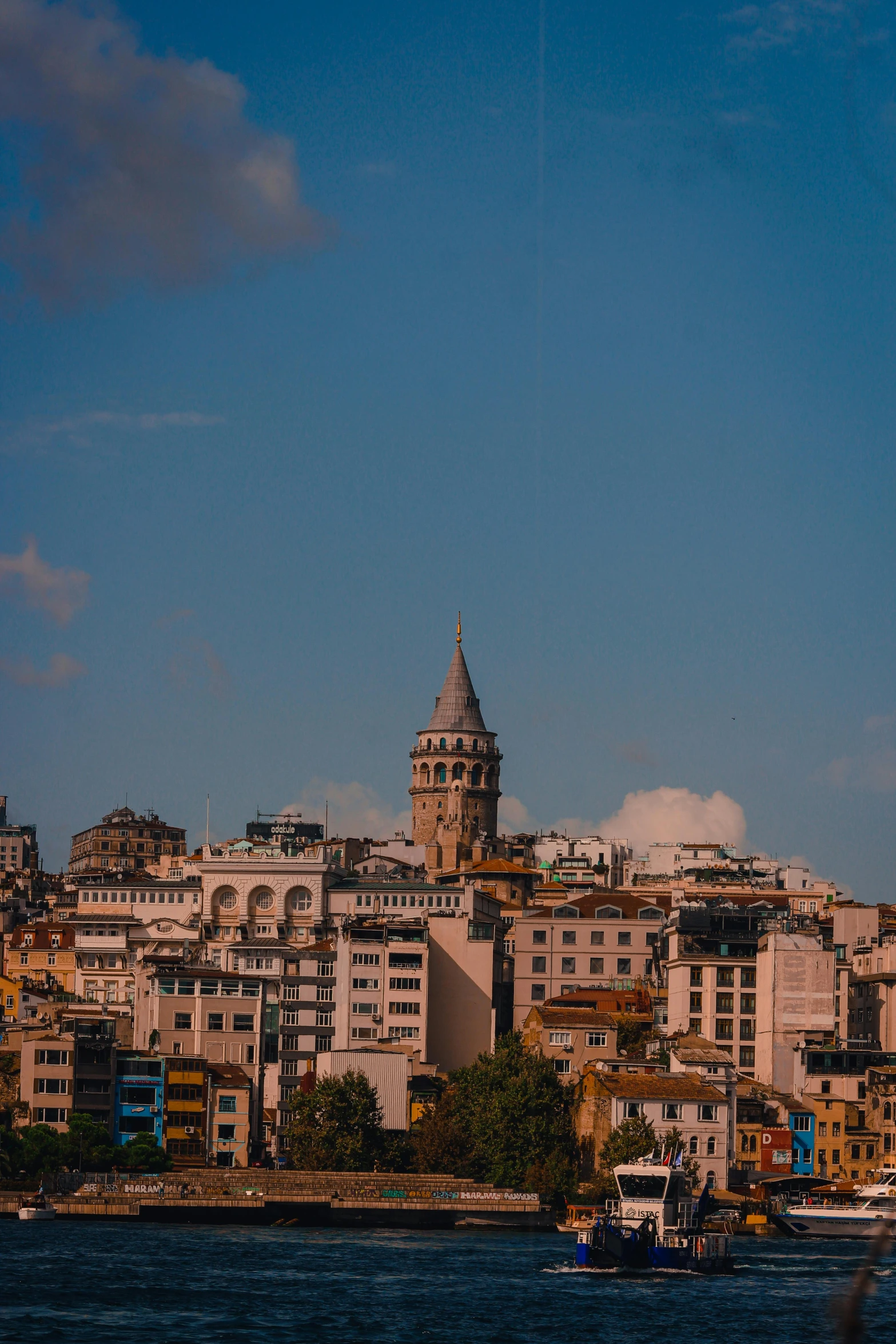 large clock tower on top of building next to water