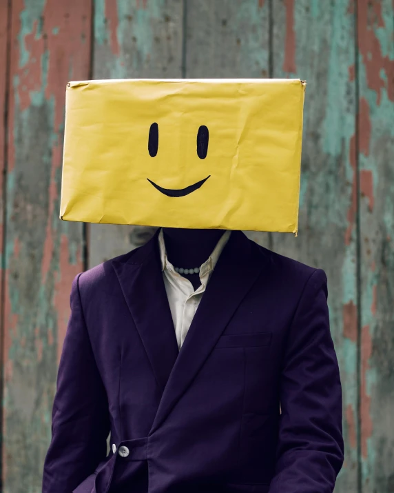 a person with a paper bag over their head with a smiling face