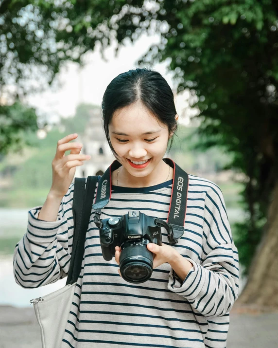 a young asian woman looking at a camera