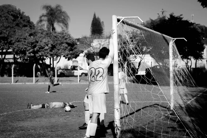 a young soccer player standing by the net