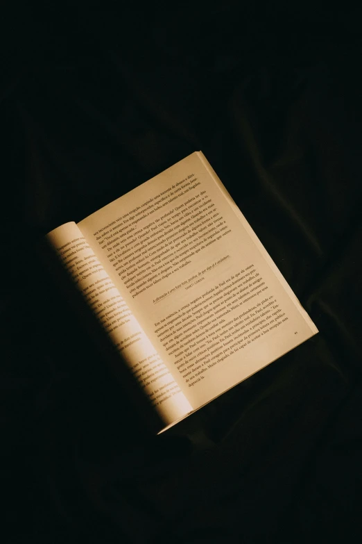 the pages of an old book lay on top of a table