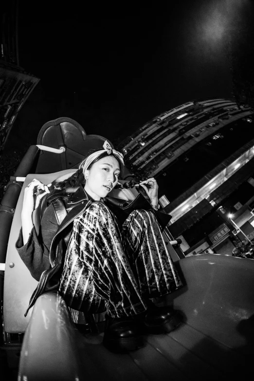 a woman sitting on the ground wearing a costume