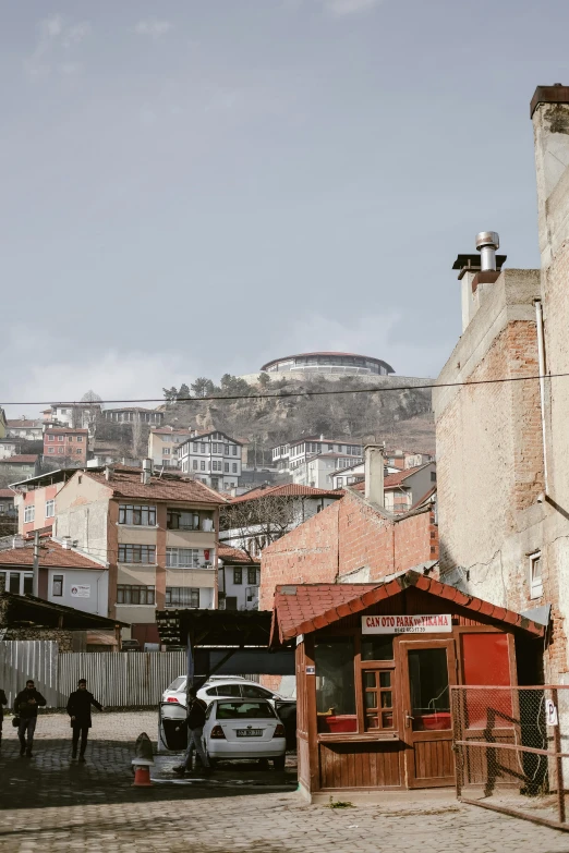 the small buildings have roofs on the mountainside