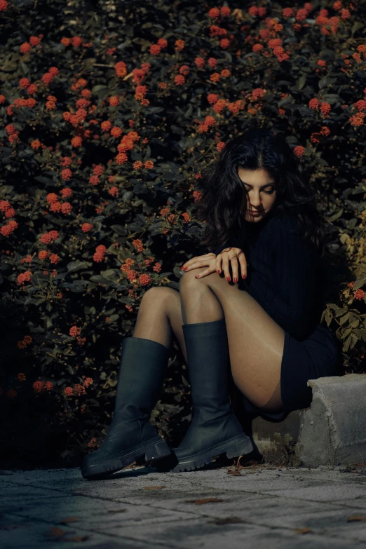 a woman with long hair sitting on a bench