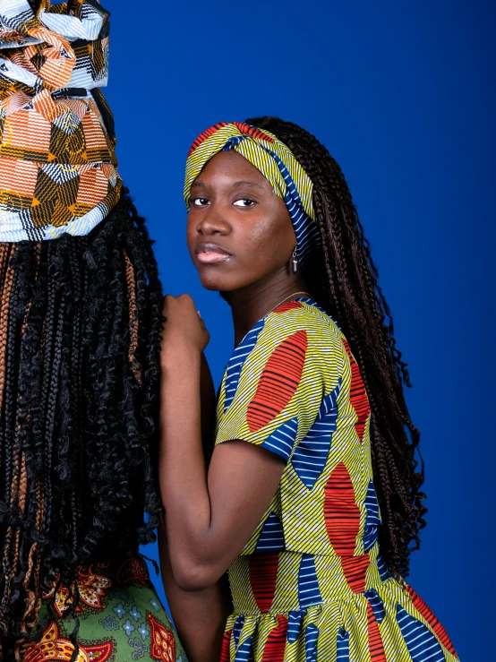 two women dressed in brightly colored clothing posing for the camera