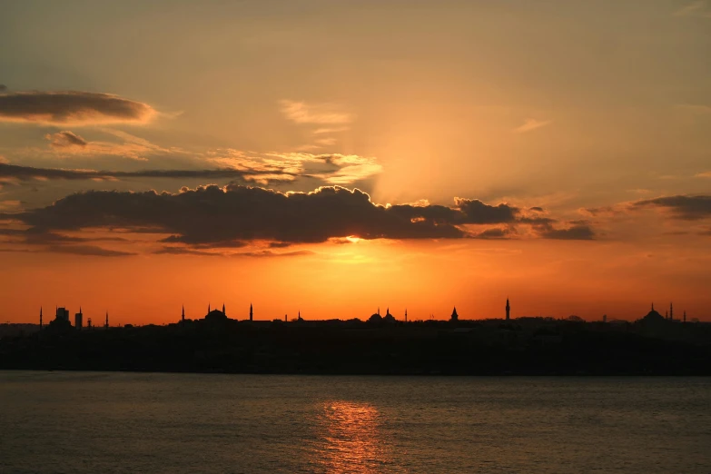 a beautiful sun in the sky at sunset over a city