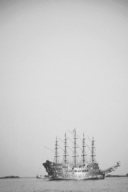 a black and white image of a pirate ship out on the water