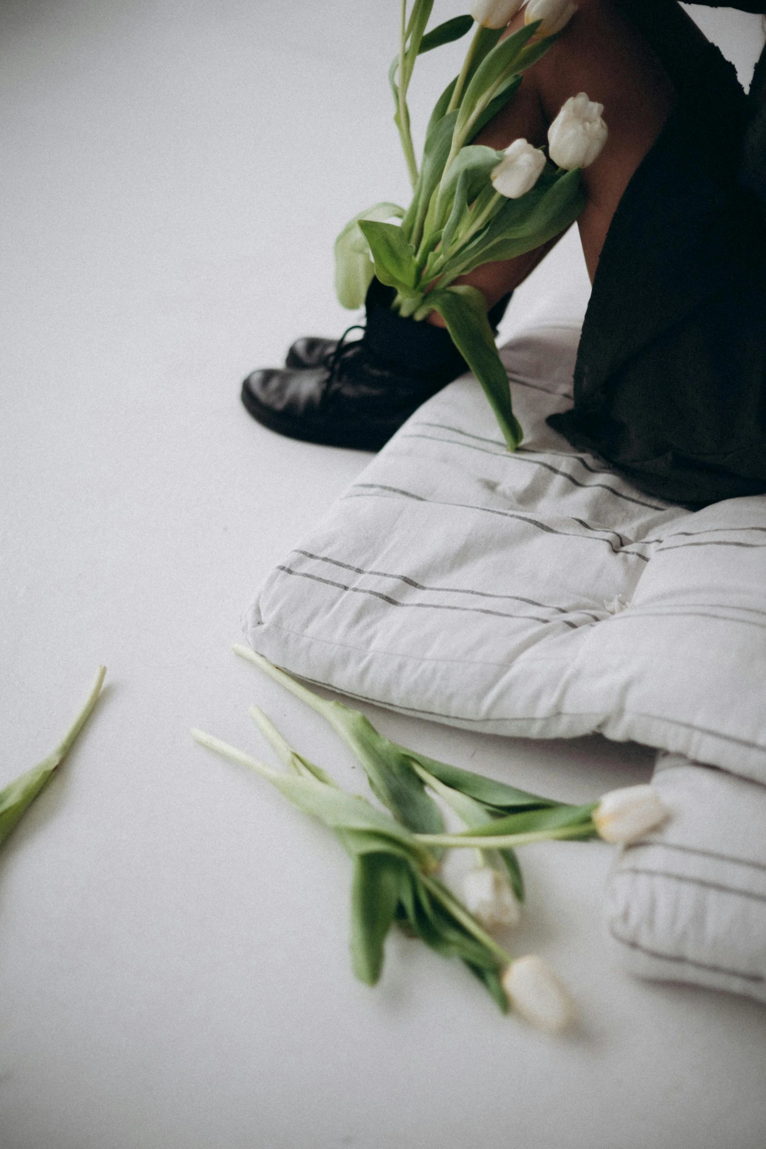 a person sitting on top of white pillows