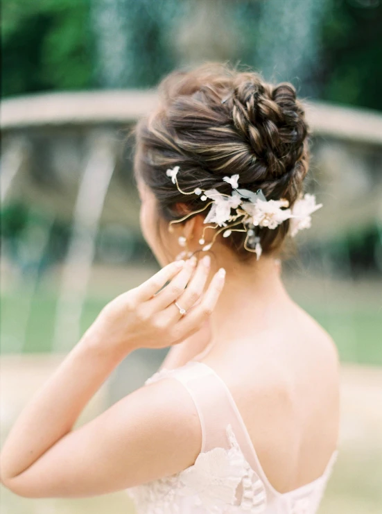 woman wearing a flower in her hair and wearing a dress with lace detail