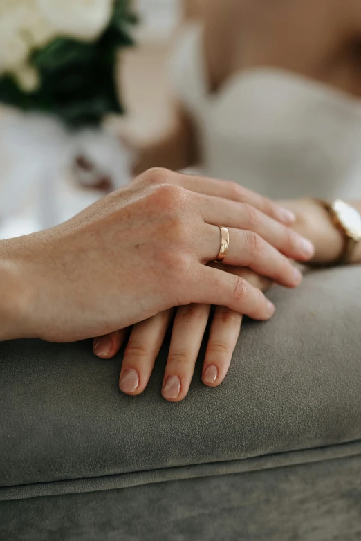 a person holding onto a seat with their hands