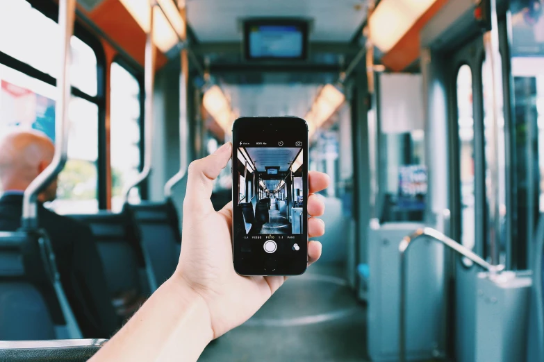 a person is taking a picture on a bus