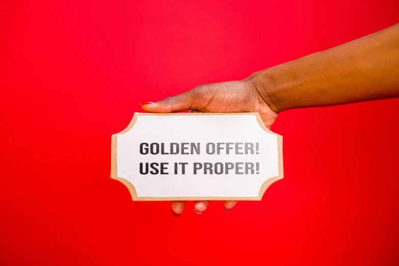 a person is holding a sign that says golden offer use it proper