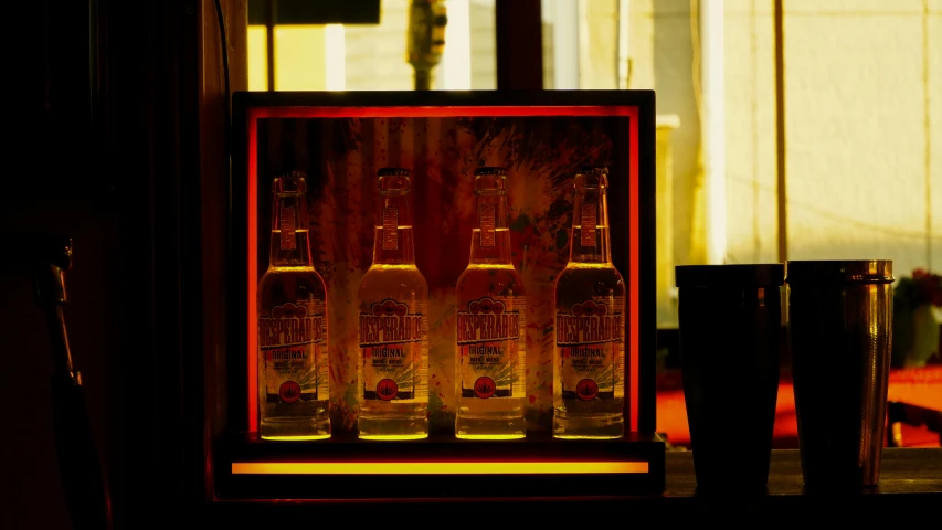 a group of beer bottles sit inside of a cabinet