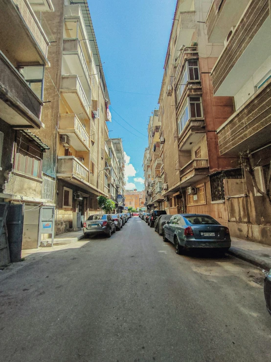 cars drive through a city with many buildings