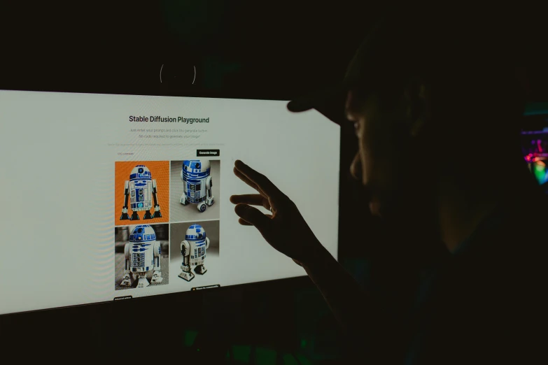 a person pointing at a screen with star wars pictures on it