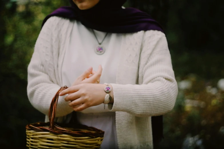 a woman with her hand on a wicker basket