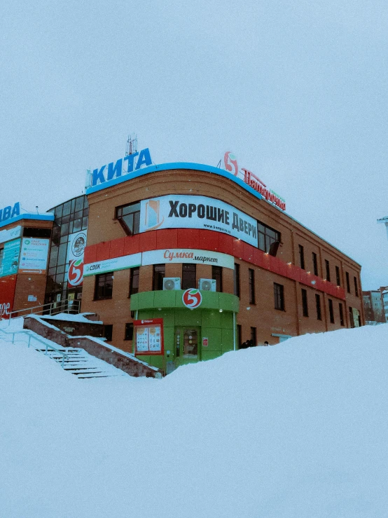 a red and green building in the snow