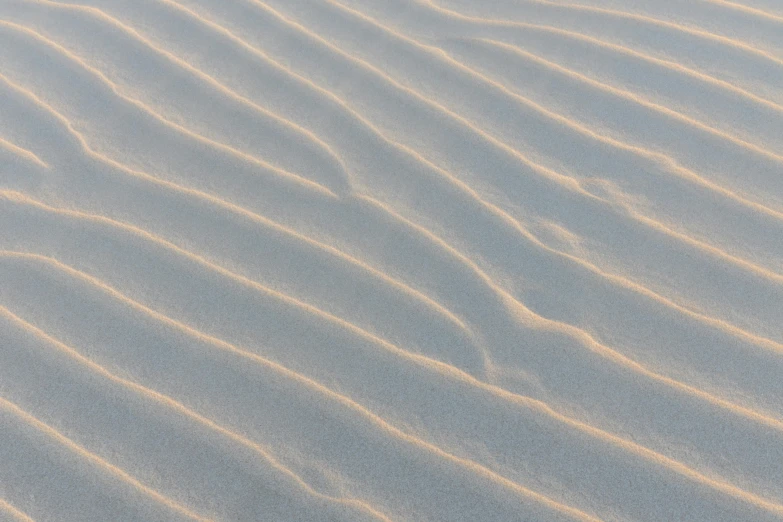 white lines are painted on the sand in the beach