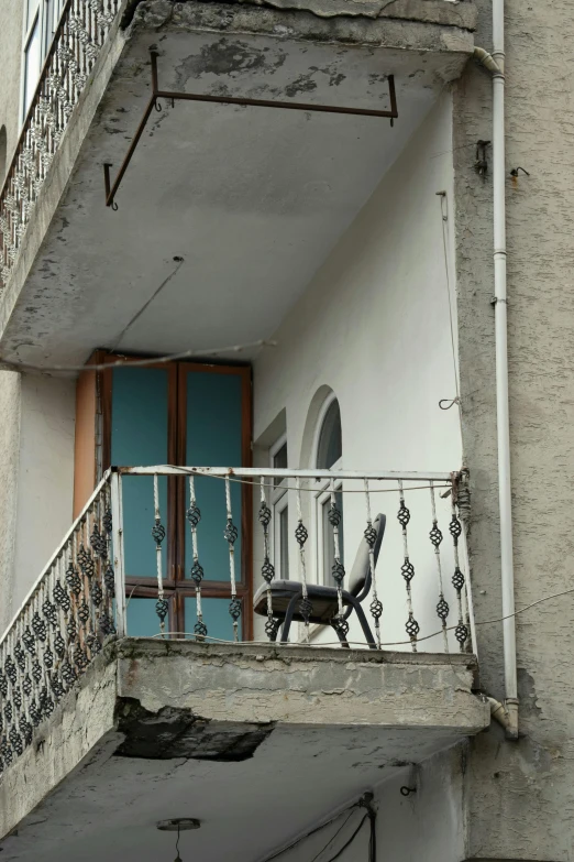 a balcony on an apartment building with iron railings