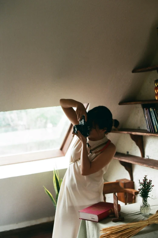 a young woman takes pictures with her camera