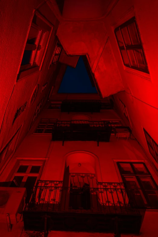 the view from the bottom of a building in red light