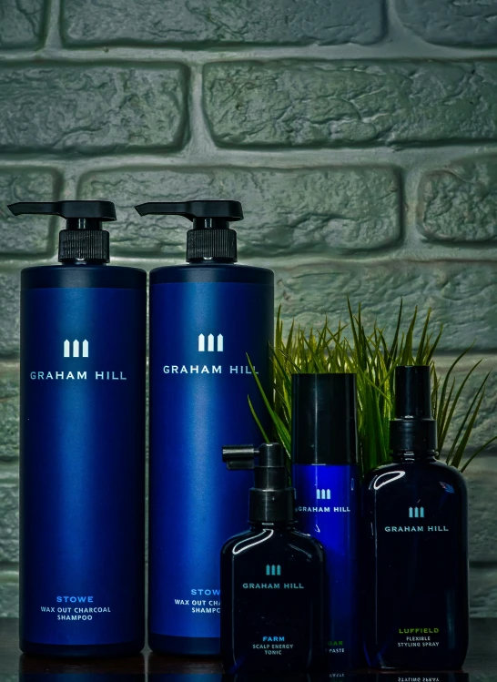 three bottles of groom care are sitting on a counter