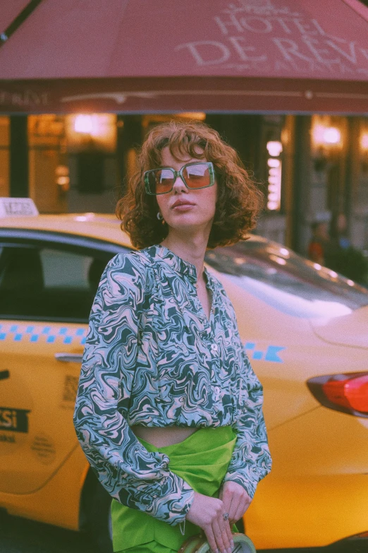 a woman is standing by a taxi at night