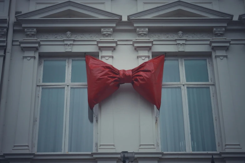 an old building with a bow tie on it