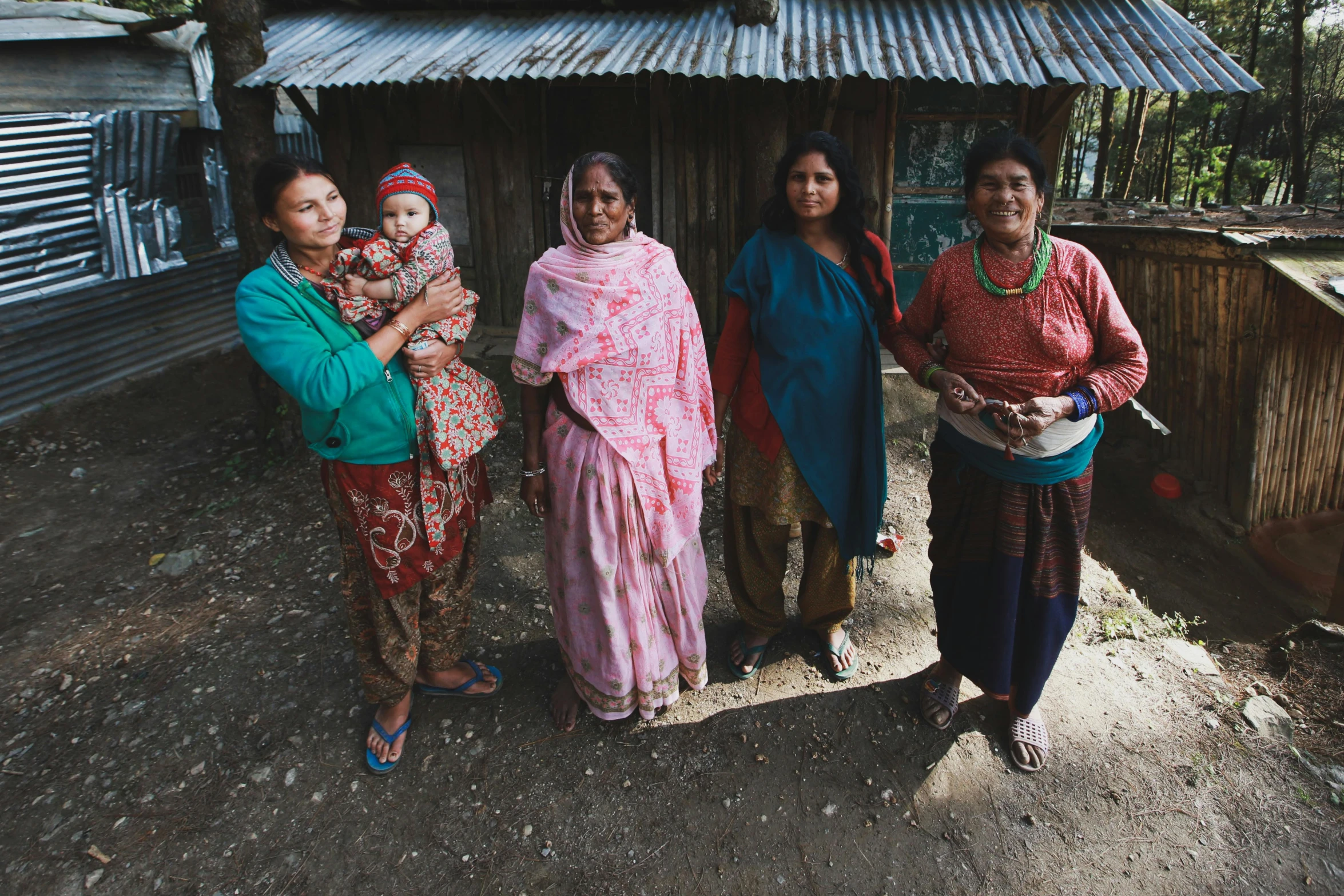 four women standing on a street in india