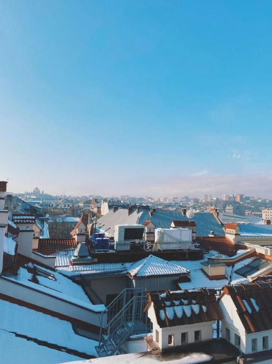 the rooftops of some building are covered in snow