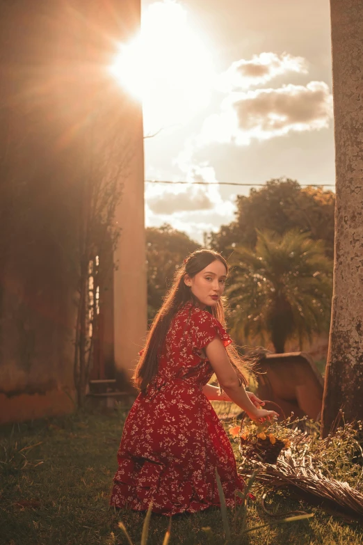 a girl in red walking by some trees