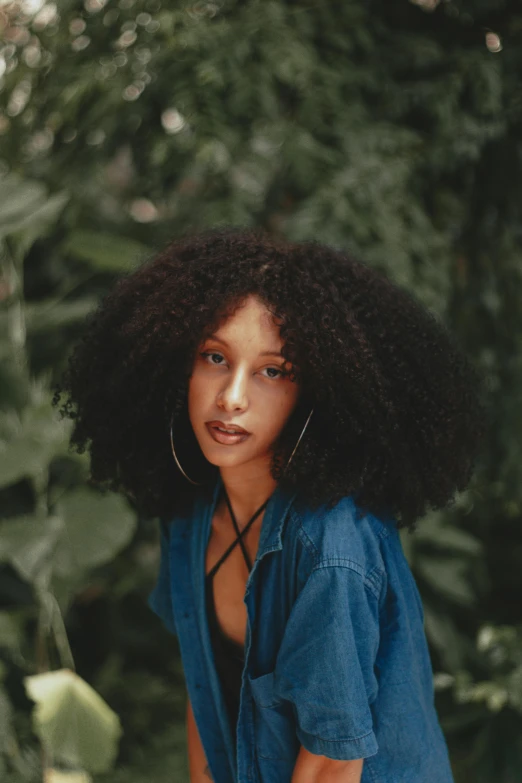 an african american woman with long hair and large hoop earrings