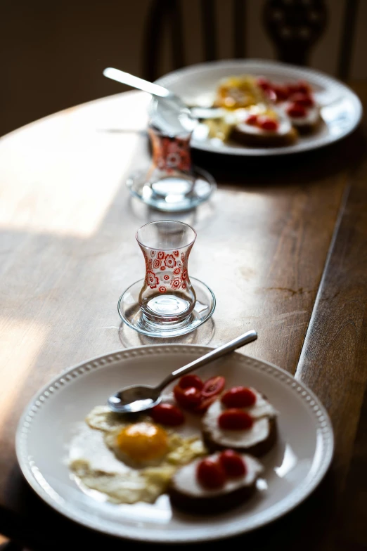 eggs, tomatoes, and other toppings on a wooden table