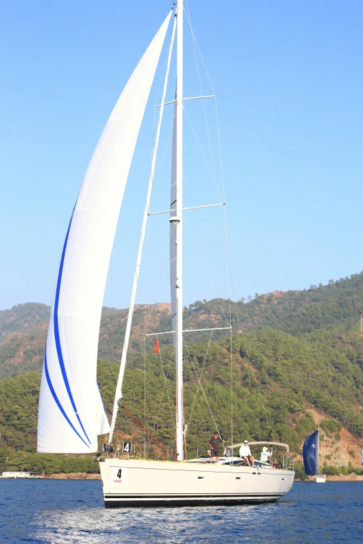 a large white sail boat with white sails