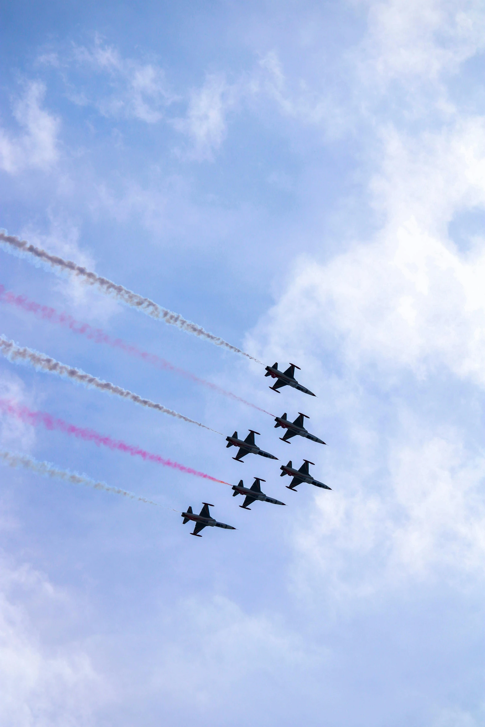 four airplanes in the sky during a performance