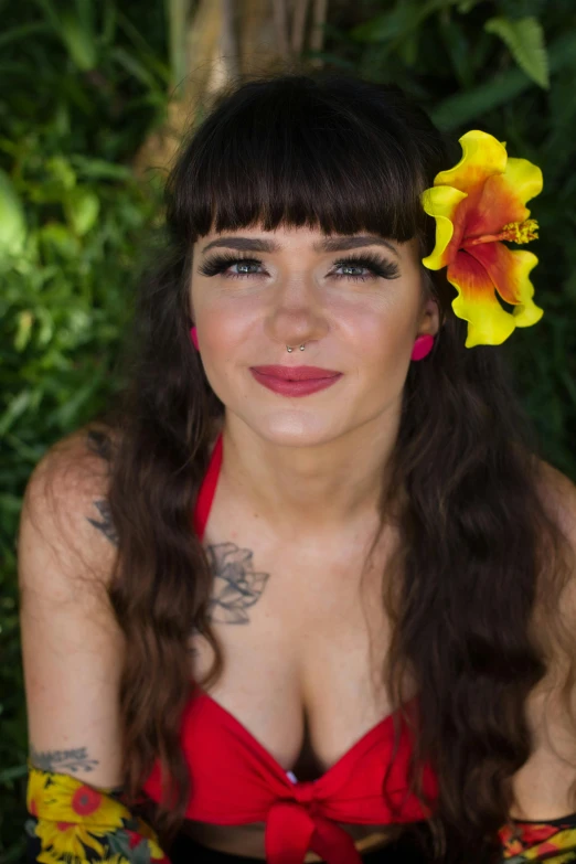 woman with tattoos sitting down and posing for a picture