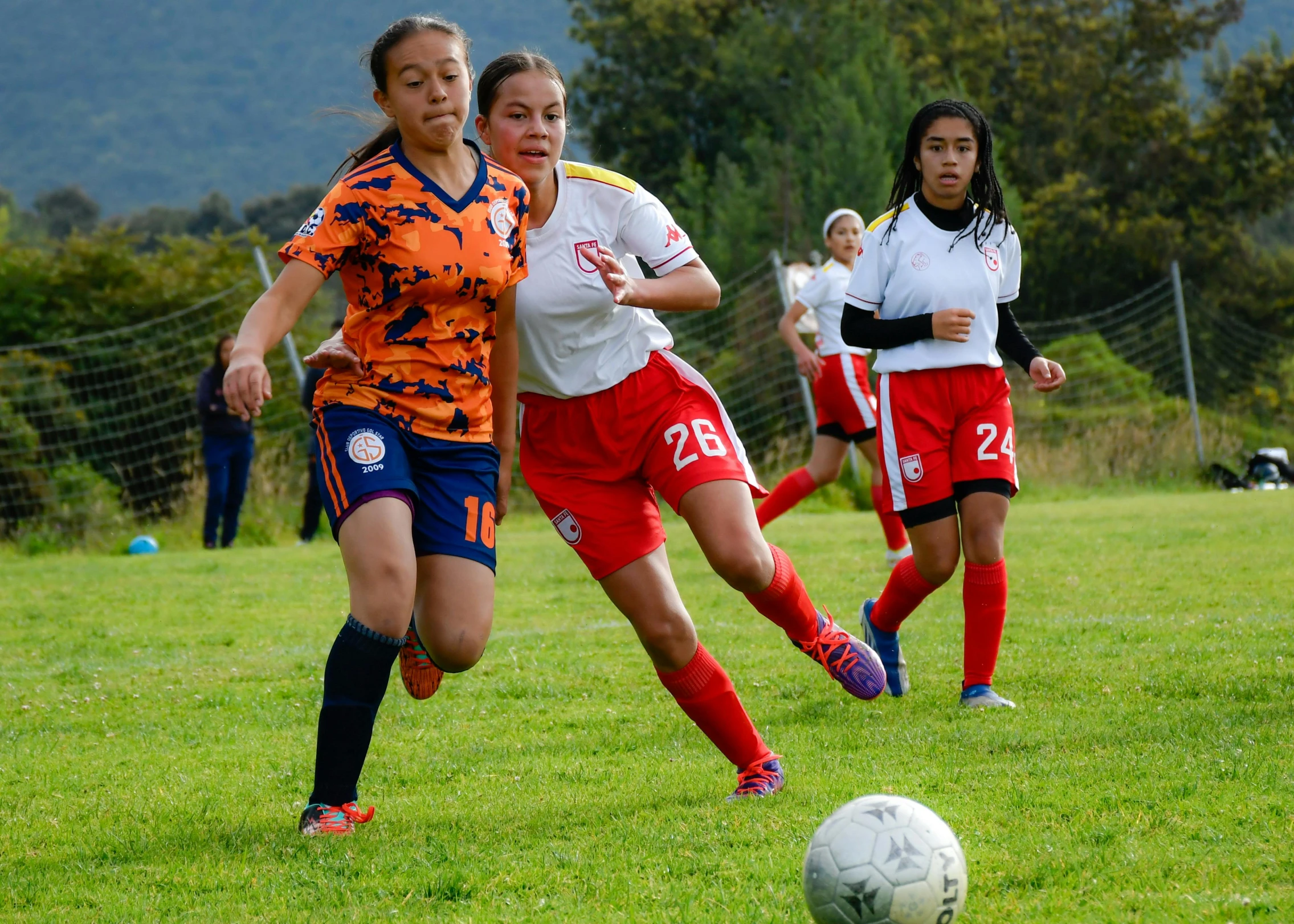 the women are playing a game of soccer