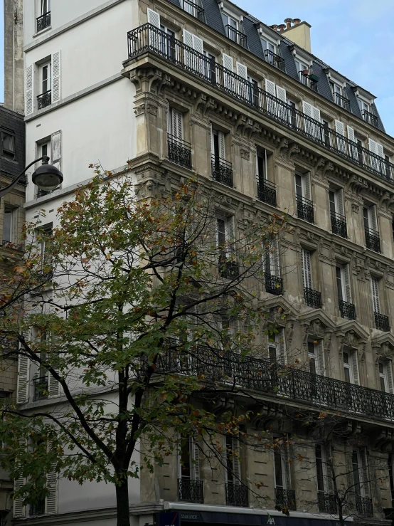 the corner of a building with balconies and windows