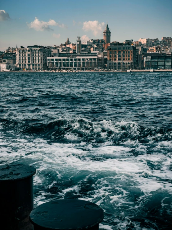 a large body of water sitting under a blue cloudy sky