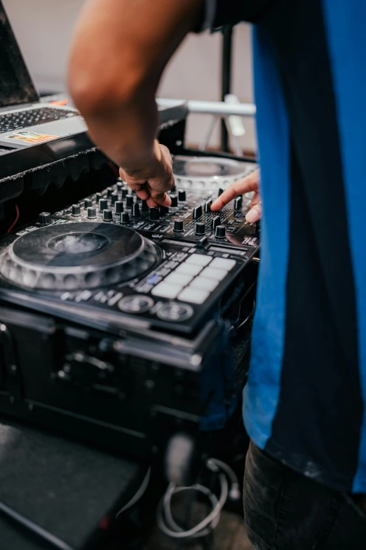 a man that is standing up in front of a dj mixer