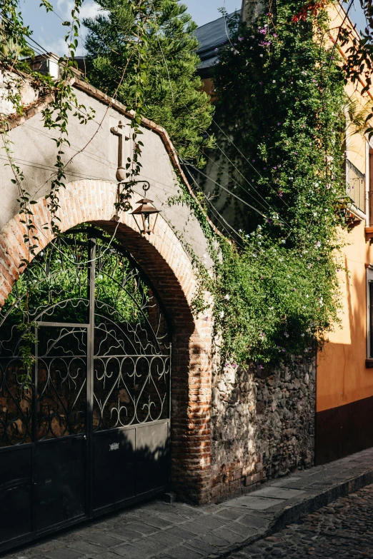 an old brick building with a black gate